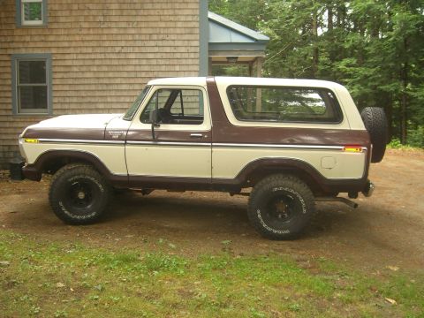 1979 Ford Bronco - This 1979 Ford Bronco is shown in a side profile, a two-tone paint scheme of brown and cream, with its spare tire mounted externally on the…