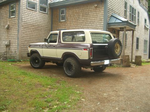 1979 Ford Bronco - This 1979 Ford Bronco is parked on a dirt driveway next to a wooden house.