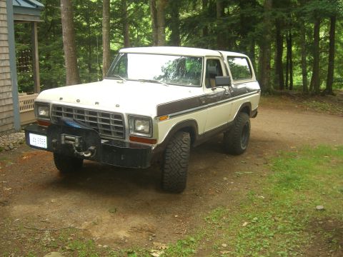1979 Ford Bronco - This Ford Bronco, likely a 1978 model, is parked in a wooded area next to a building.