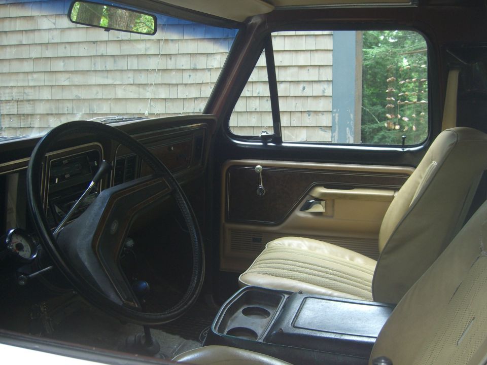 1979 Ford Bronco interior with tan seats and wood-grain trim