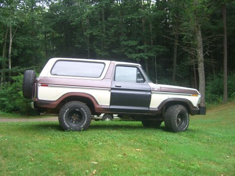 1979 Ford Bronco - This Ford Bronco is parked on a grassy lawn with trees in the background.