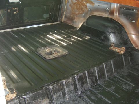 1979 Ford Bronco - Interior view of a vehicle's cargo area, showing the ribbed floor and a floor access panel.