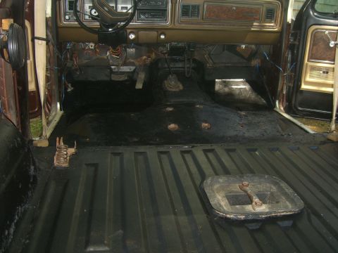 1979 Ford Bronco - The interior of a 1979 Ford Bronco shows a stripped-down floor and dashboard.