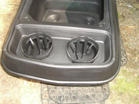 1979 Ford Bronco - Close-up of a vehicle's center console, two cup holders.