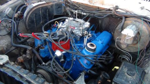 1979 Ford Bronco - Engine bay view of a V8 motor with blue painted valve covers and intake manifold.
