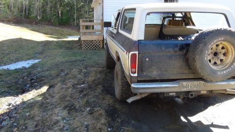 1979 Ford Bronco - Rear view of a 1978 Ford Bronco with a two-tone paint job and a spare tire on the back.