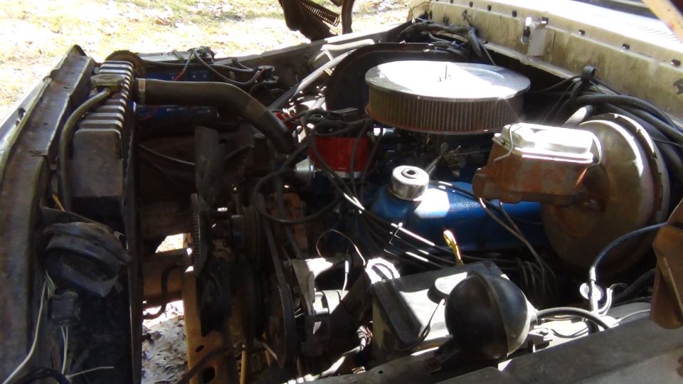 1979 Ford Bronco engine bay with V8 engine, air cleaner, radiator, and brake booster