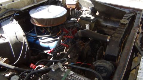 1979 Ford Bronco - The engine compartment shows various components including the air filter, radiator, and battery.