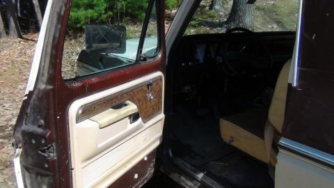 1979 Ford Bronco - Interior view of a 1979 Ford Bronco, focusing on the driver's side door and dashboard.