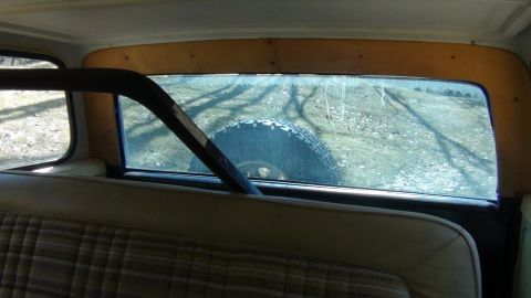 1979 Ford Bronco - Interior view of a classic SUV, showing the rear seat and a spare tire mounted externally.