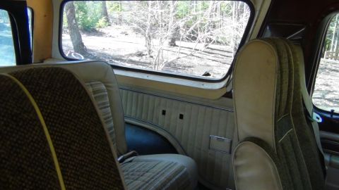 1979 Ford Bronco - The interior of a 1978 Ford Bronco is visible, with patterned seats and a view of the outdoors through the window.