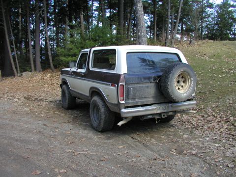 1979 Ford Bronco - This 1979 Ford Bronco is parked outdoors, a two-tone paint scheme and a spare tire mounted on the rear tailgate.