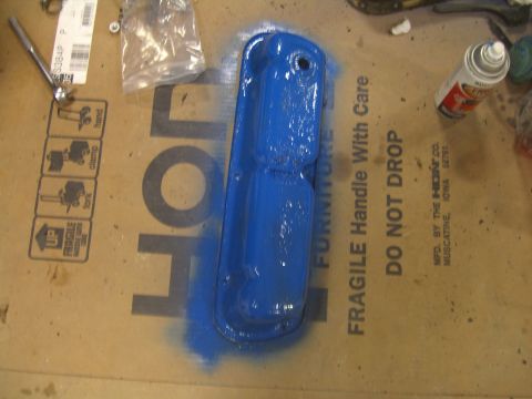 1979 Ford Bronco - A blue painted engine part rests on a cardboard box with shipping labels and instructions.
