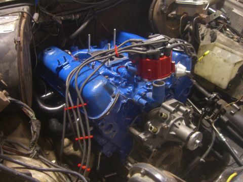 1979 Ford Bronco - Close-up view of a vehicle's engine bay, a bright blue engine block and associated components.