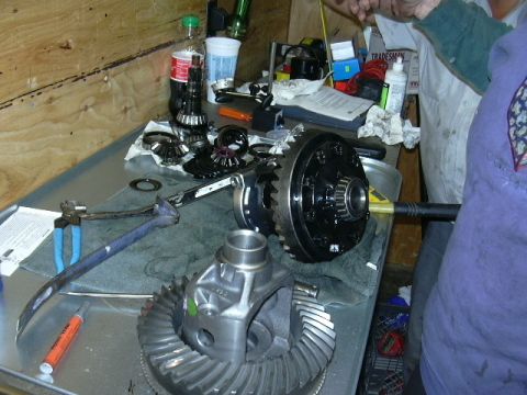 1991 Ford Bronco - Differential components are laid out on a workbench, suggesting a repair or installation process.