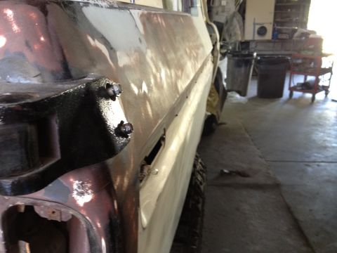 1979 Ford Bronco - Side view of a 1979 Ford Bronco undergoing bodywork in a garage.