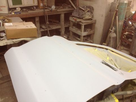 1979 Ford Bronco - A car door is shown in a workshop setting, ready for bodywork or painting.