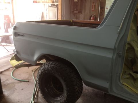 1979 Ford Bronco - Side view of a 1978 Ford Bronco's rear quarter panel and tire, prepped for paint.