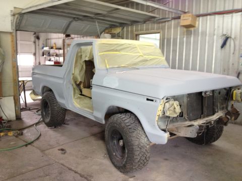 1979 Ford Bronco - This 1979 Ford Bronco is in the process of being prepped for paint, showing its body style and undergoing repairs in a garage setting.