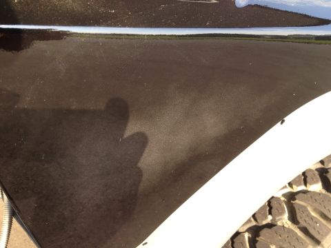 1979 Ford Bronco - Close-up of a vehicle's side panel and tire, with a watermark from Supermotors.net.