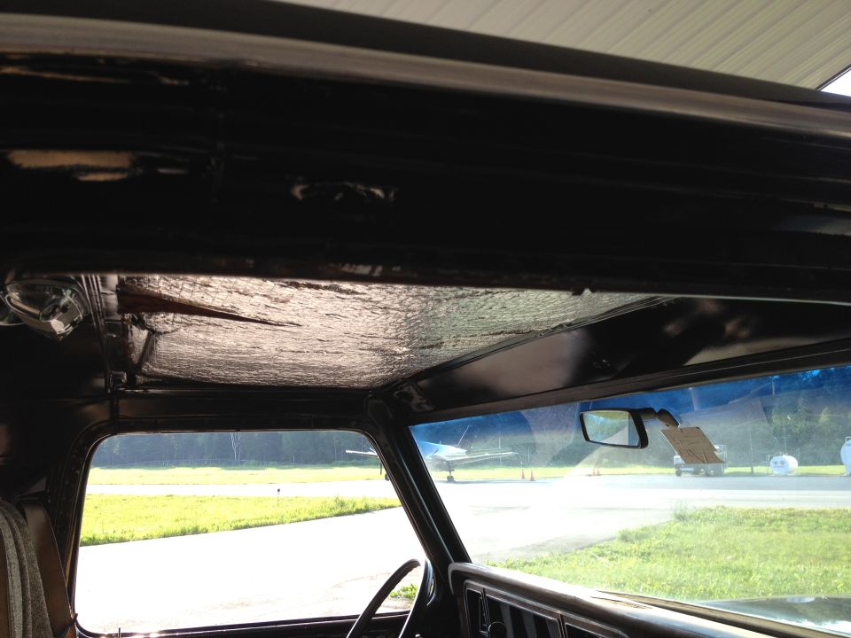 1979 Ford Bronco interior showing headliner and windshield view of airfield