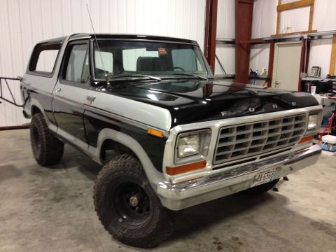1979 Ford Bronco - This Ford Bronco is parked indoors, showing its two-tone paint and tires.