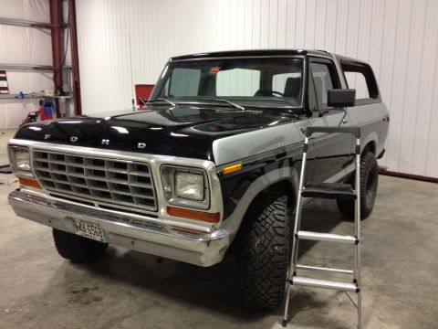 1979 Ford Bronco - This 1979 Ford Bronco features a distinctive black and silver two-tone paint scheme and is presented in a 3/4 front view.