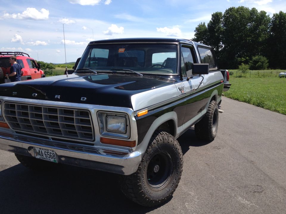 Two-tone black and silver Ford Bronco with aftermarket wheels and tires, parked on asphalt