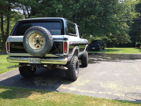 1979 Ford Bronco - A lifted 1978 Ford Bronco is parked in a driveway next to another vehicle.