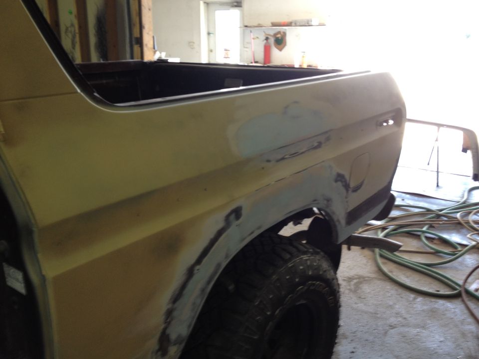 Yellow 1979 Ford Bronco rear quarter panel with body filler