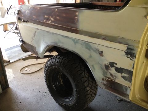 1979 Ford Bronco - The vehicle is in a garage, being prepped for paint with visible body filler and primer.