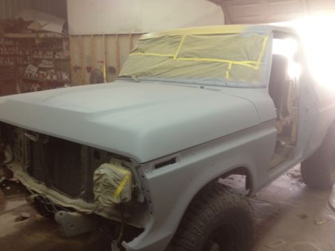 1979 Ford Bronco - This 1979 Ford Bronco is in a workshop, with its front end masked and prepped for bodywork and painting.