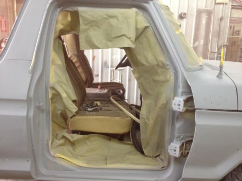 1979 Ford Bronco - The interior of a 1979 Ford Bronco is masked with paper, ready for a paint job.