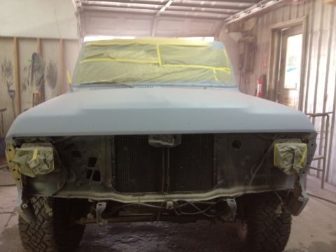 1979 Ford Bronco - This truck is being prepped for painting in a workshop. The front end is covered in masking tape.
