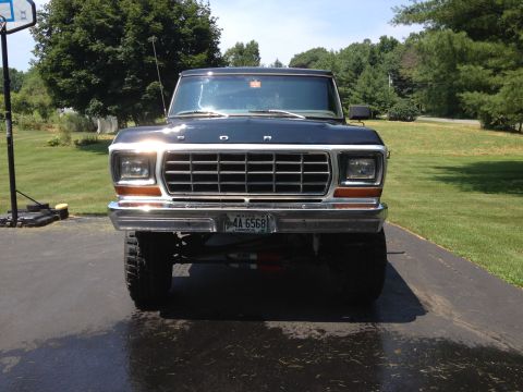 1979 Ford Bronco - This Ford Bronco features a prominent grille and large tires, seen from the front.
