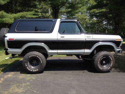 1979 Ford Bronco - This two-tone 1979 Ford Bronco features a classic side profile, lifted suspension, and aggressive off-road tires.