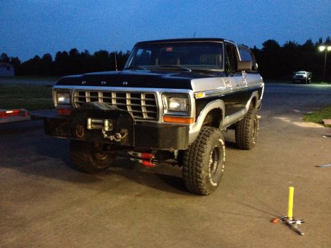 1979 Ford Bronco - This modified 1979 Ford Bronco features a prominent winch and heavy-duty bumper, ready for off-road adventures.