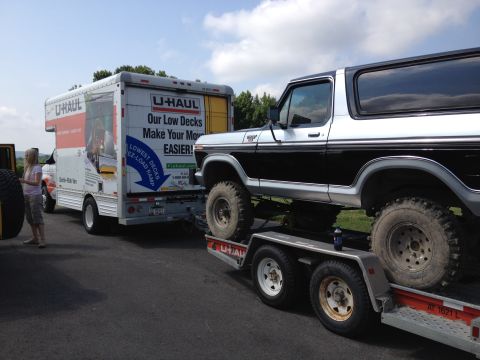1979 Ford Bronco - Ford Bronco loaded onto a trailer, with a U-Haul truck in the background.