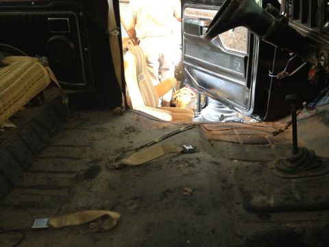 1979 Ford Bronco - Vehicle interior undergoing work, likely a 1978 Ford Bronco, with floor stripped bare.