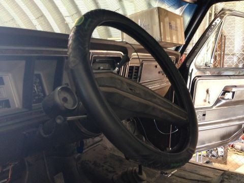 1979 Ford Bronco - The interior of a 1979 Ford Bronco is visible, with a focus on the dashboard and steering wheel.