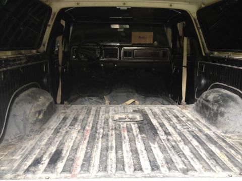 1979 Ford Bronco - The interior of a 1979 Ford Bronco is shown, with the cargo bed and front cabin visible.
