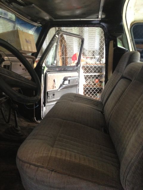 1979 Ford Bronco - Interior view of a 1979 Ford Bronco, highlighting the seats and the open driver's side door.