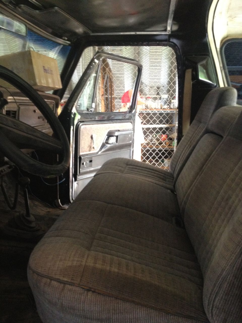 Interior view of 1979 Ford Bronco showing seats and open door