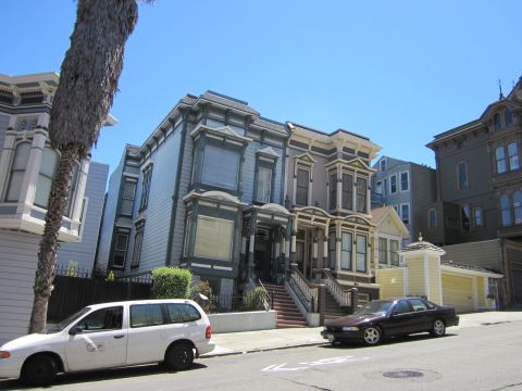 1991 Ford LTD Crown Victoria - A street scene in San Francisco features Victorian architecture and parked vehicles under a clear blue sky.