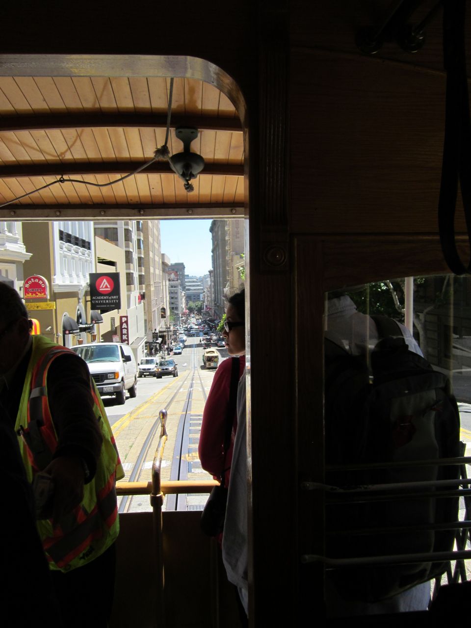 San Francisco street scene viewed from a cable car, showing buildings and traffic
