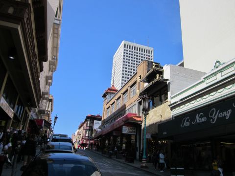1991 Ford LTD Crown Victoria - A street scene in San Francisco shows buildings and vehicles under a clear blue sky.