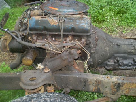 1979 Ford Bronco - This is a close-up view of a rusty engine and transmission assembly, likely removed from a vehicle.