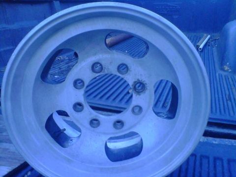 1994 Ford Bronco - Aluminum truck wheel with five lug holes and large cutouts is shown.
