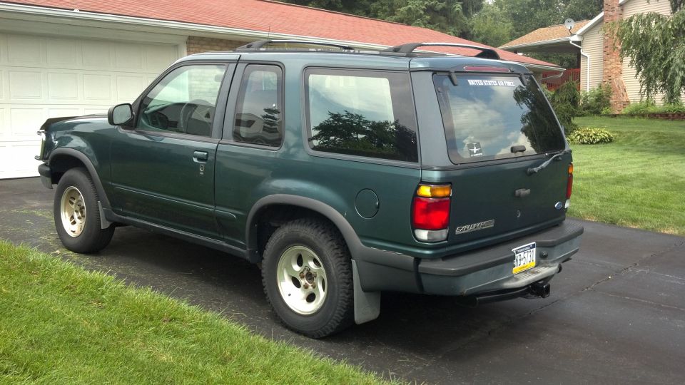 Green 1996 Ford Explorer parked in driveway, rear quarter view