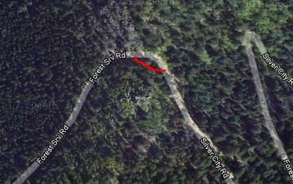 1995 Ford Bronco - An aerial perspective shows a forest road, with a red arrow highlighting a specific turn.